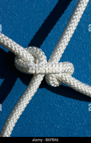 Clove hitch with white rope on blue surface Stock Photo