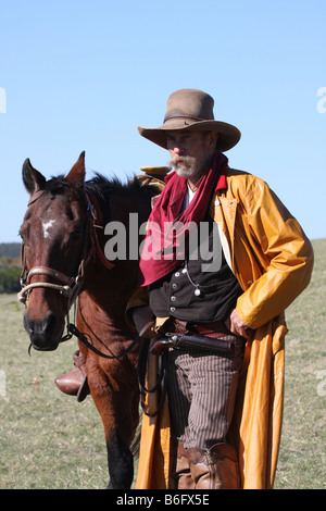 There is a bond between a cowboy and his horse out on the range Stock Photo