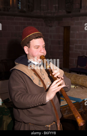 UK Cheshire Chester Cathedral at Christmas Tom Hughes playing a medieval Rauschpfeife Stock Photo