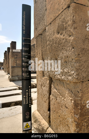 The street and the audioguide sign on Via dell Abbondanza, Pompeii, Campania, Italy, Europe. Stock Photo
