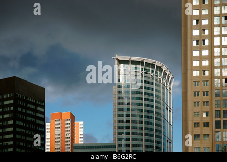 Skyscrapers buildings modern tall bank facades in Rotterdam city center under dark cloud dramatic sky Stock Photo