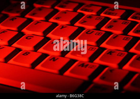 Close-up image of a keyboard lit by red light Stock Photo