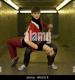 Contemporary dancers striking a pose in a city subway Stock Photo