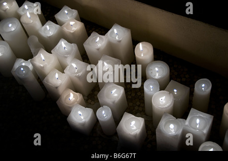 Lit white candles. Stock Photo