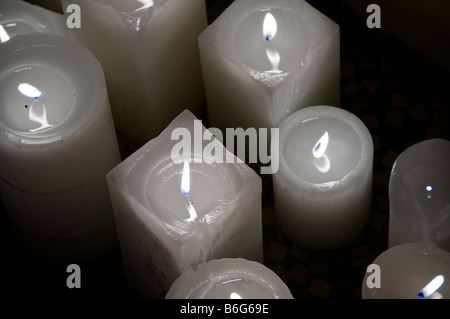 Close-up of lit white candles. Stock Photo