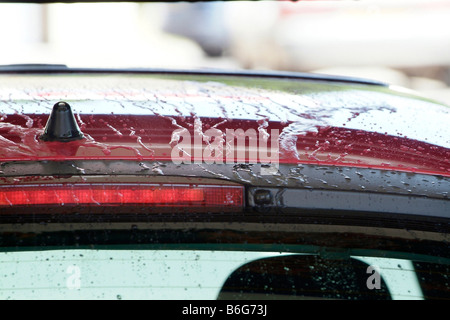 Detail of water beading on vehicle bodywork in a car wash Stock Photo