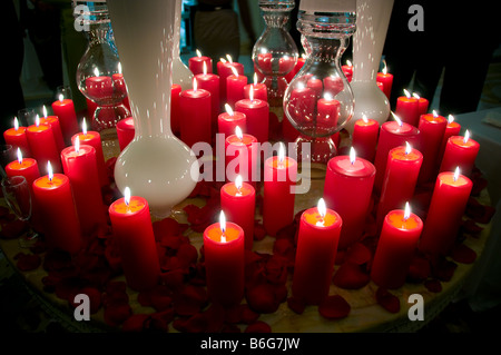 Lit red candles on table. Stock Photo