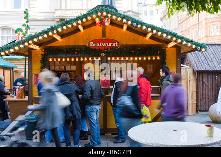 Customers queue for Bratwurst at a stall on Manchester Continental market