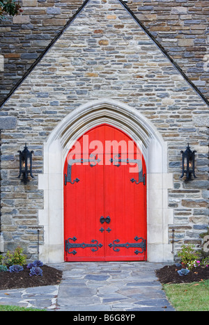 Red church doors on a old stone church Stock Photo