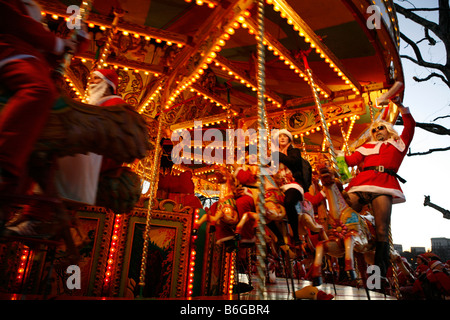 Santacon 2006. Santas on a Merry go round in London. Hundreds of pranksters dressed as Santas take over the streets of London Stock Photo