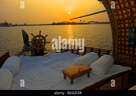 Sunset looking out from traditional Kettuvallam houseboat in the Backwaters of Kerala India Stock Photo