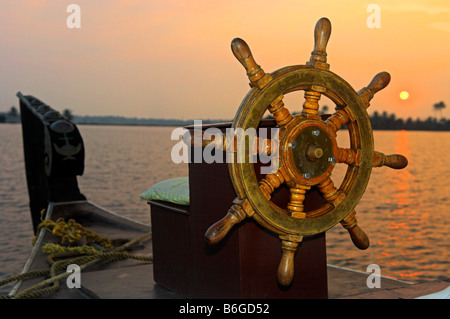Steering wheel of traditional  Kettuvallam houseboat in the Backwaters of Kerala at sunset India Stock Photo