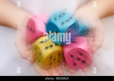 Dice on hands Stock Photo