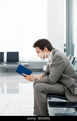 Man sitting reading book Stock Photo