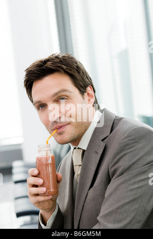 Close up of guy drinking from paper cup isolated on white studio ...
