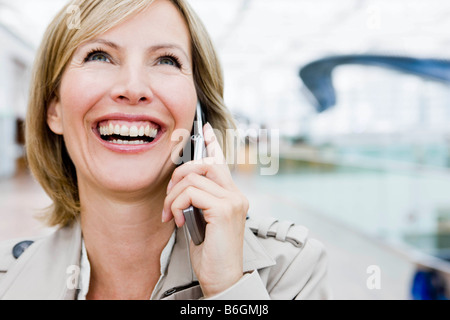 Woman smiling using cell phone Stock Photo