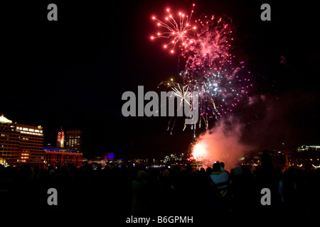 Spectators watch a Firework display from Blackfrairs Bridge on The River Thames in London after the Lord Mayors show Stock Photo