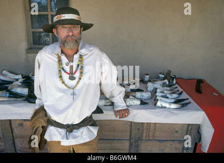 A mountain man makes powder horns from cow horns for flintlock muzzle loading rifles at the Mountain Man Rendezvous Stock Photo