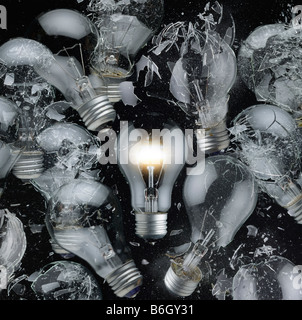 One light bulb glowing, many broken Stock Photo