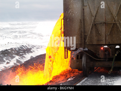 This is one of the more spectacular sights in the mining industry. Pouring slag is very much like flowing lava. Stock Photo