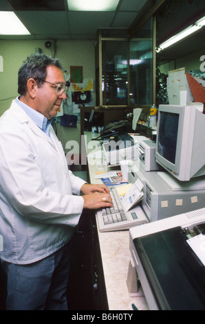 Technician uses computer at workstation in lab. pharmacist Stock Photo
