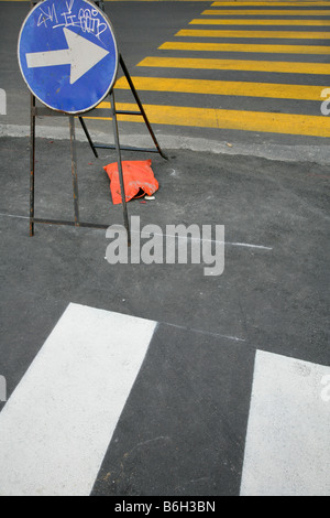Temporary turn right sign at pedestrian crossing. Stock Photo