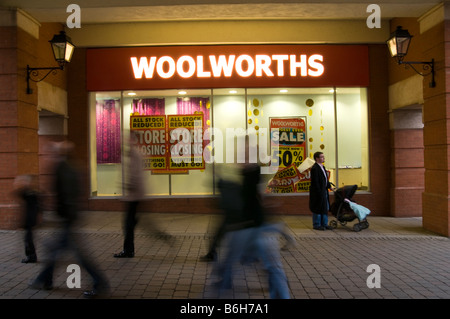 Blurred figures/people walking past Woolworths shop front Chesterfield Store Derbyshire England UK Stock Photo