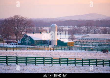 Sunrise on a barn and grain silo after a fresh snowfall, Brentwood, Tennessee Stock Photo