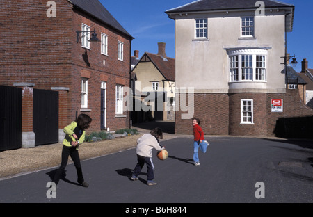 Children playing in the street in Poundbury Dorset village designed on Prince Charles architecture ideas EDITORIAL USE ONLY Stock Photo