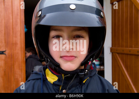 Young boy wearing motorcycle helmet Stock Photo