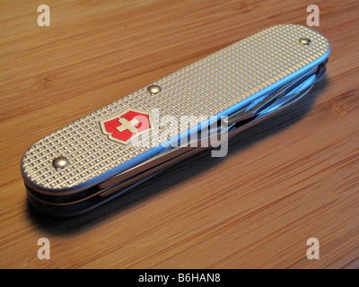 Swiss Army knife on wooden surface. Stock Photo