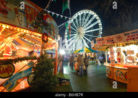 Cardiff Winter Wonderland's carousels and funfair in front of the 'Admiral Eye' Stock Photo