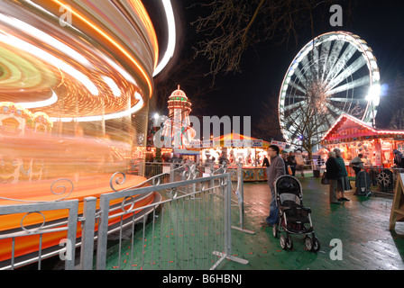 Cardiff Winter Wonderland's carousels and funfair in front of the 'Admiral Eye' Stock Photo