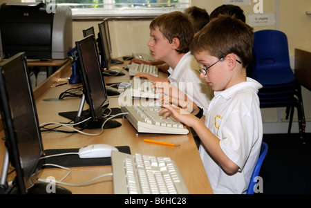 Primary school pupils using computers in classroom Stock Photo - Alamy