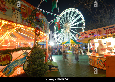 Cardiff Winter Wonderland's carousels and funfair in front of the 'Admiral Eye' Stock Photo