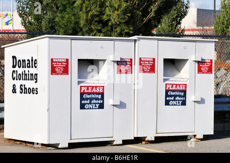 2 two donate clothing bins outside in parking lot Stock Photo