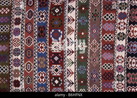 Colorful geometric patterns on a traditional, handmade, woolen Turkish kilim rug. Stock Photo