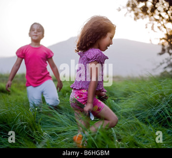 two girls having fun in high grass Stock Photo
