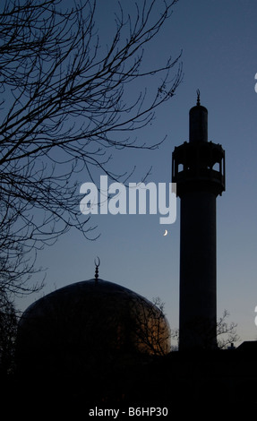 Three crescents: Silhouette of London Central Mosque and Islamic Cultural Centre at dusk with new moon in sky, London Stock Photo