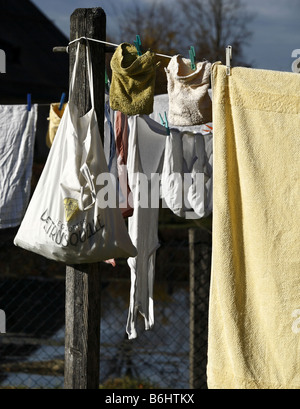 Clothes Peg Bag Hanging on Wooden Post and Clothes Line Stock Photo