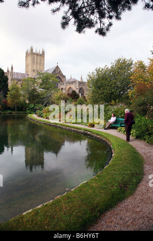 Wells Cathedral reflected in the wells, from which the city gets its name, inside the grounds of the Bishops Palace