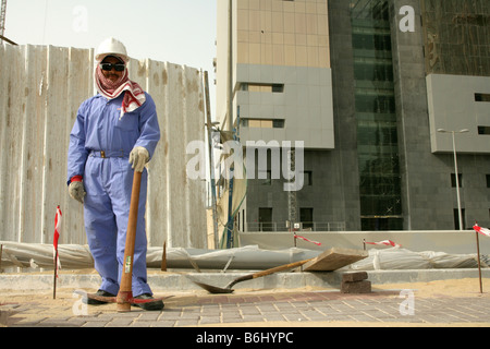 Migrant construction worker on construction site wearing sunglasses and hard hat, portrait, Doha, Qatar, Middle East Stock Photo