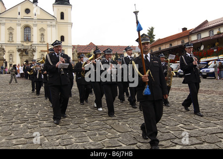 The conductor runs a brass band during a religious ceremony in Kalwaria Zebrzydowska, Poland Stock Photo