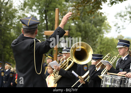 The conductor runs a brass band during a religious ceremony in Kalwaria Zebrzydowska, Poland Stock Photo