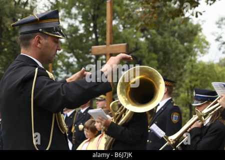 The conductor runs a brass band during a religious ceremony in Kalwaria Zebrzydowska, Poland Stock Photo