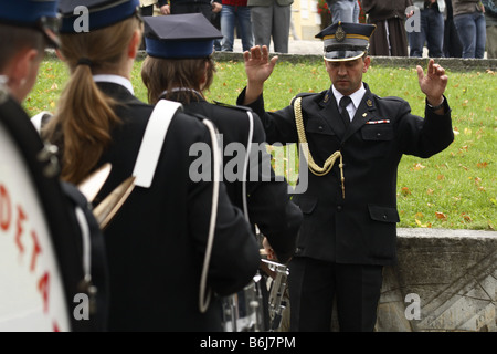 The conductor runs a brass band during a religious ceremony in Kalwaria Zebrzydowska, Poland Stock Photo