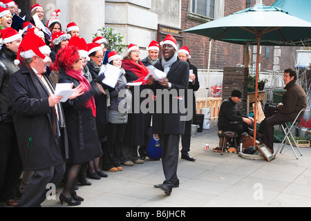 Carol singers and shoe polisher outside St. Mary Le Bow Church at Cheapside City of London England Stock Photo