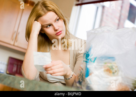 Woman checking shopping prices Stock Photo