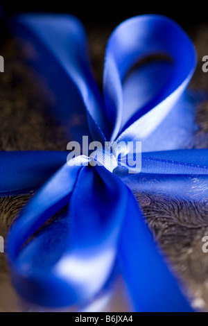 Blue Ribbon Tied in a Bow on Silver Gift High Resolution Image Shot with Macro Lens Carefully Spotted and Retouched Stock Photo