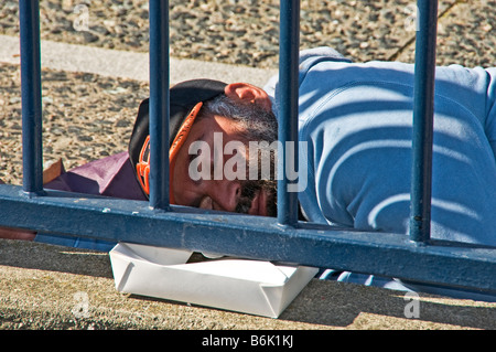 Homeless man sleeping in a park bench Stock Photo - Alamy